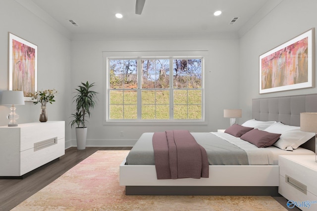 bedroom with hardwood / wood-style floors, ceiling fan, and crown molding