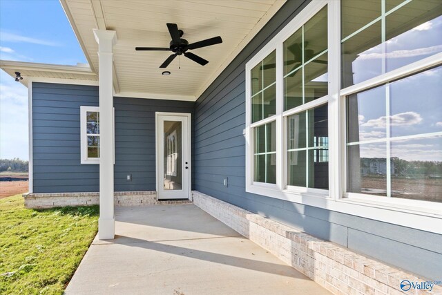 view of exterior entry with ceiling fan