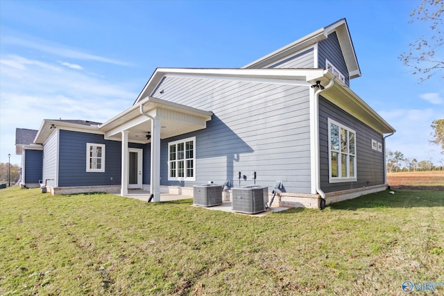 back of property with a yard, ceiling fan, a patio area, and central air condition unit