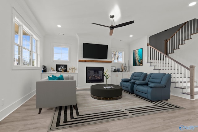 living room featuring ceiling fan and light wood-type flooring