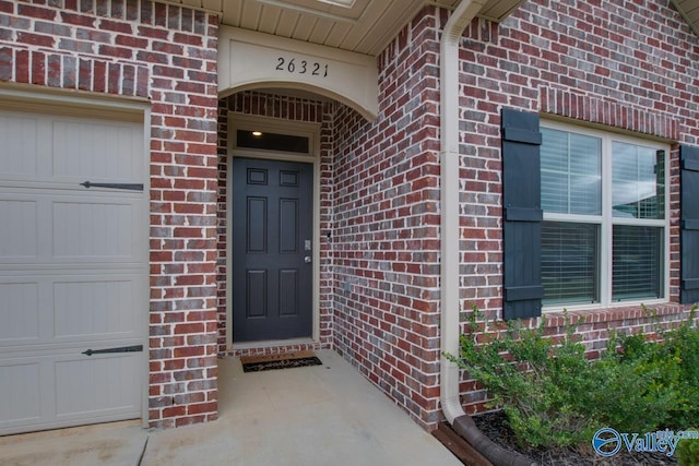 view of exterior entry with a garage