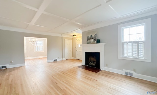 unfurnished living room with coffered ceiling, an inviting chandelier, and light hardwood / wood-style floors