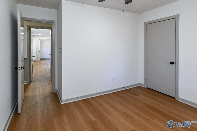 empty room featuring hardwood / wood-style flooring and ceiling fan