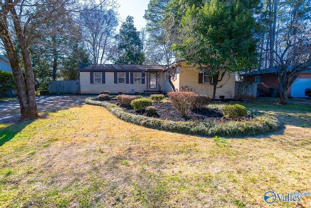 ranch-style home featuring a front yard