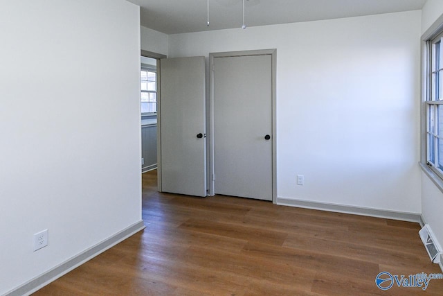 empty room featuring dark hardwood / wood-style flooring