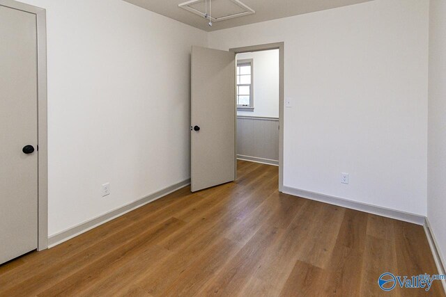 unfurnished room with hardwood / wood-style flooring