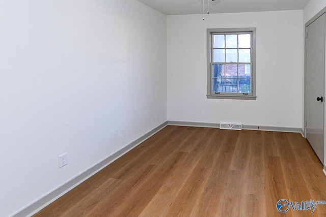 empty room featuring hardwood / wood-style flooring