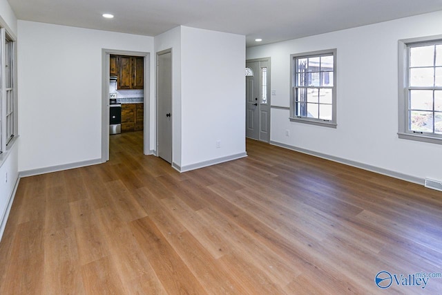 spare room with light hardwood / wood-style floors