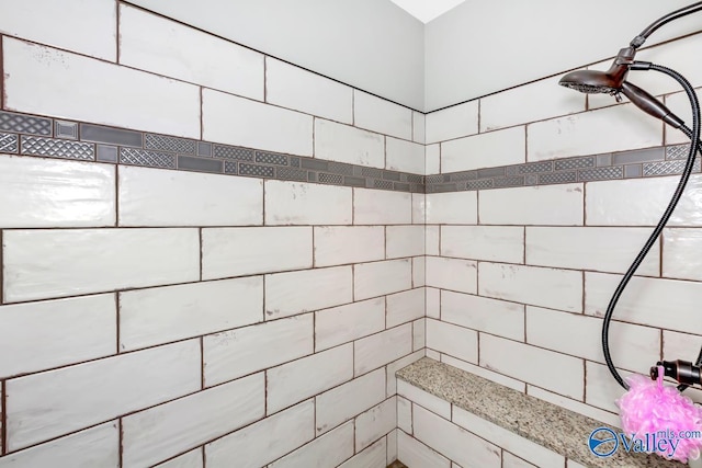 full bath with a tile shower