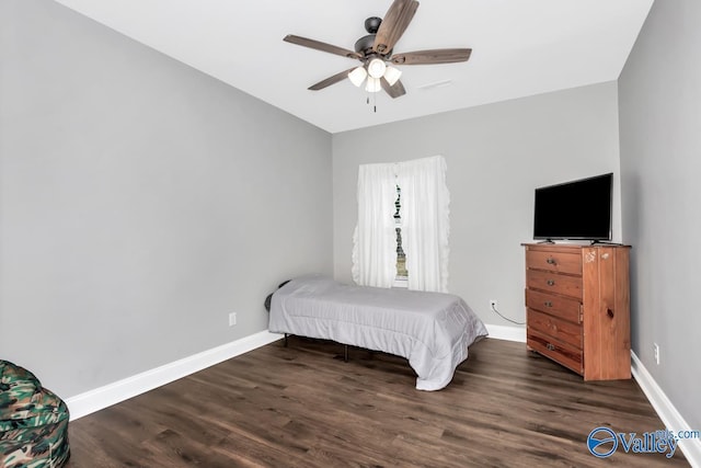 bedroom featuring ceiling fan, baseboards, and wood finished floors