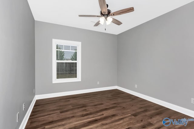 unfurnished room with dark wood-type flooring, baseboards, and a ceiling fan