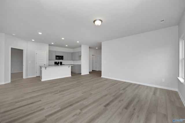 unfurnished living room featuring light hardwood / wood-style floors