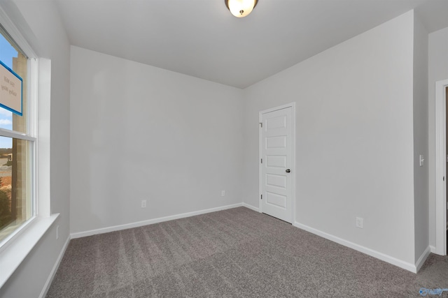 carpeted empty room featuring plenty of natural light