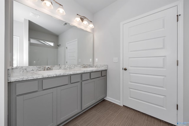 bathroom with vanity and walk in shower