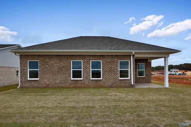 rear view of house featuring a yard and a patio area