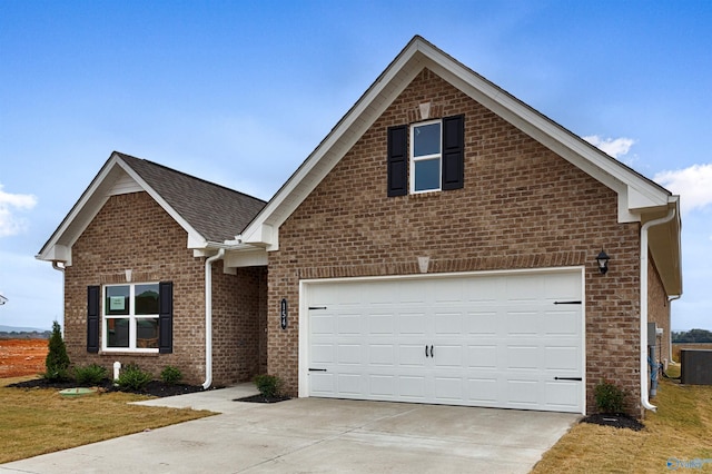 view of front property with a garage and central AC unit