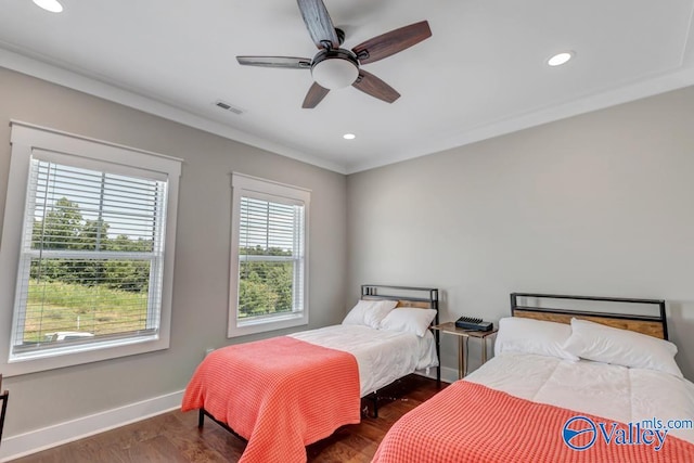 bedroom featuring crown molding, dark hardwood / wood-style floors, and ceiling fan