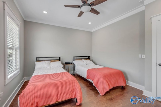 bedroom with crown molding, hardwood / wood-style floors, and ceiling fan