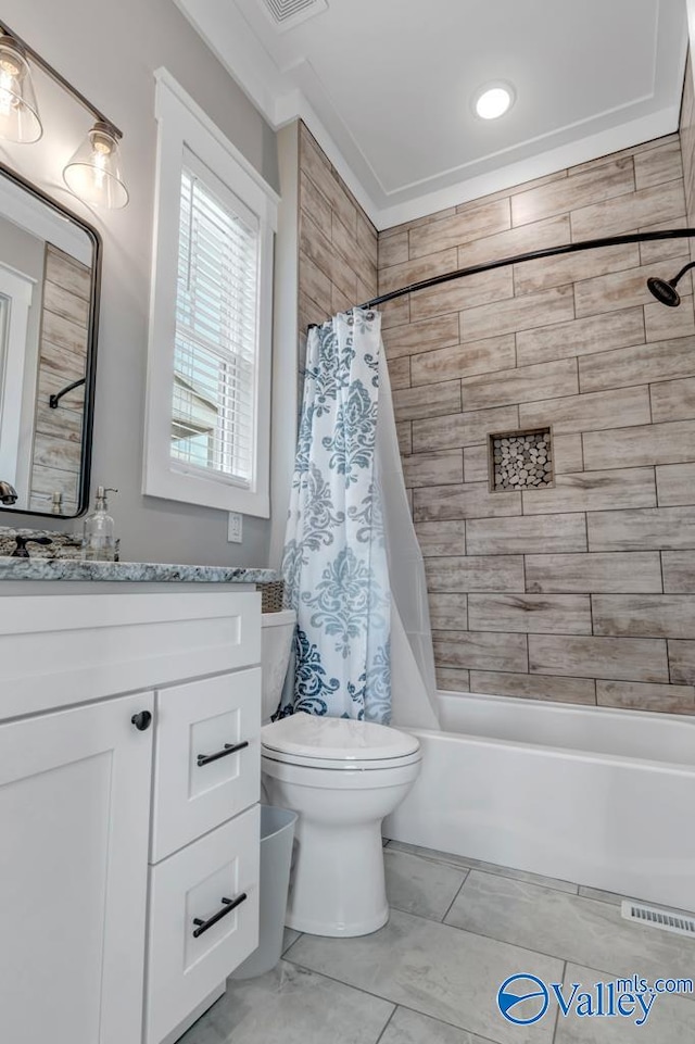 full bathroom featuring shower / bath combo with shower curtain, tile patterned floors, toilet, and vanity