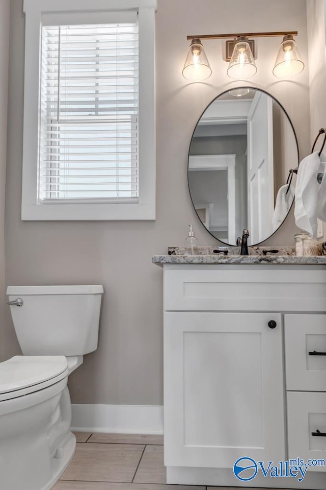 bathroom with tile patterned floors, toilet, and vanity