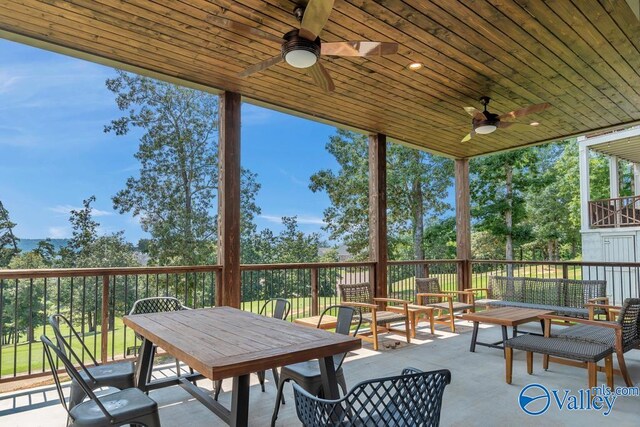 sunroom with ceiling fan and wood ceiling