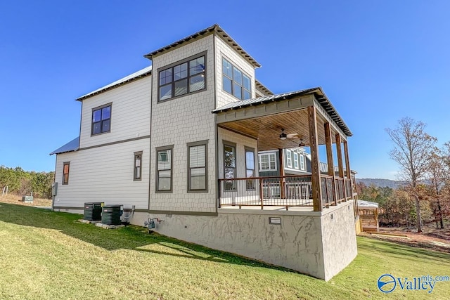 exterior space with ceiling fan, central AC, and a yard