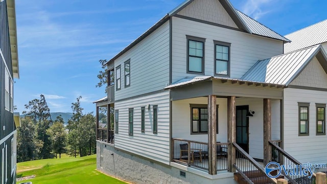 exterior space with a porch and a lawn