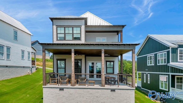 back of house featuring a porch and a lawn