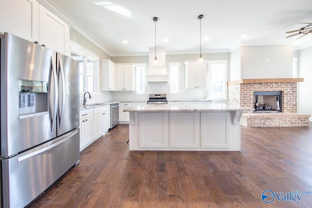 kitchen featuring decorative backsplash, stainless steel appliances, dark hardwood / wood-style flooring, and a fireplace