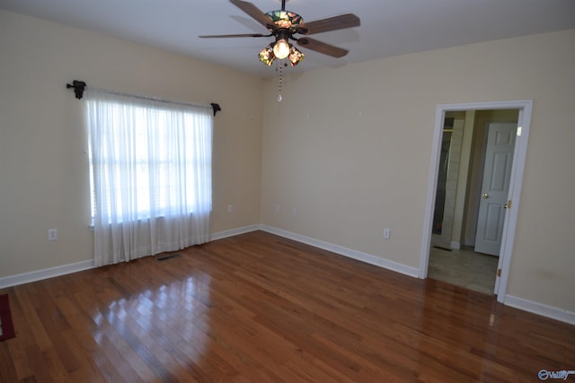 unfurnished room featuring ceiling fan and dark wood-type flooring