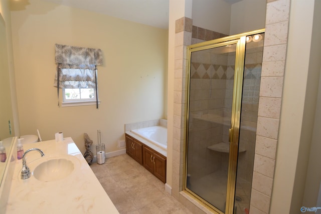 bathroom with vanity and shower with separate bathtub