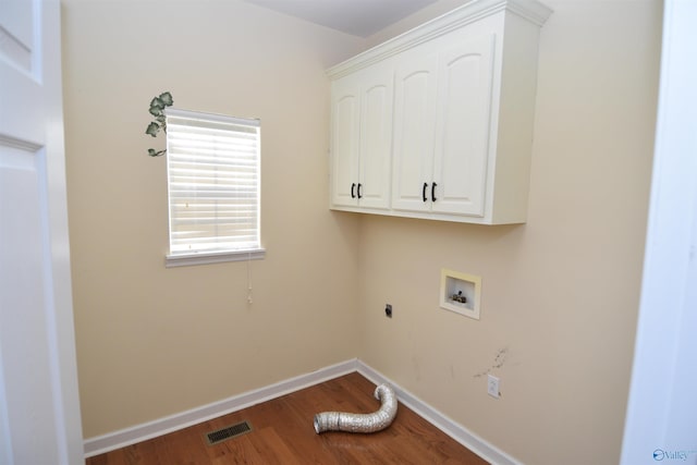 laundry area with hookup for an electric dryer, wood-type flooring, and cabinets