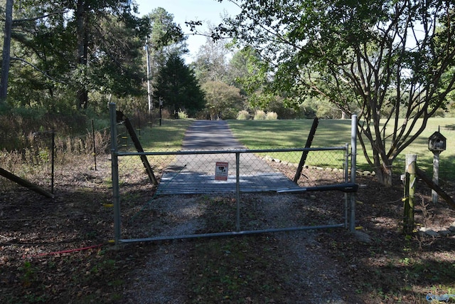 view of gate featuring a yard