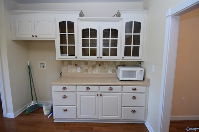 kitchen featuring tasteful backsplash, white cabinets, and dark hardwood / wood-style flooring