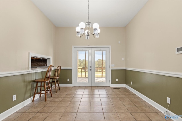 doorway featuring french doors, tile patterned flooring, and baseboards