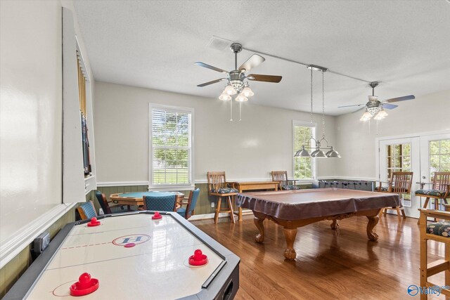 game room with ceiling fan, hardwood / wood-style floors, french doors, pool table, and a textured ceiling