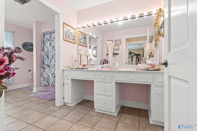 full bathroom with a shower with curtain, tile patterned flooring, baseboards, and vanity
