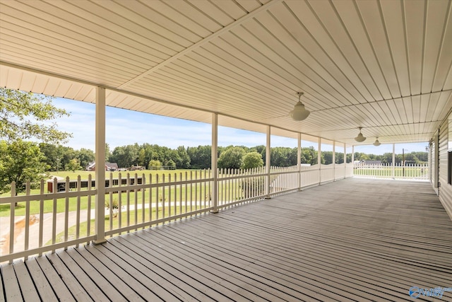 wooden deck featuring a lawn