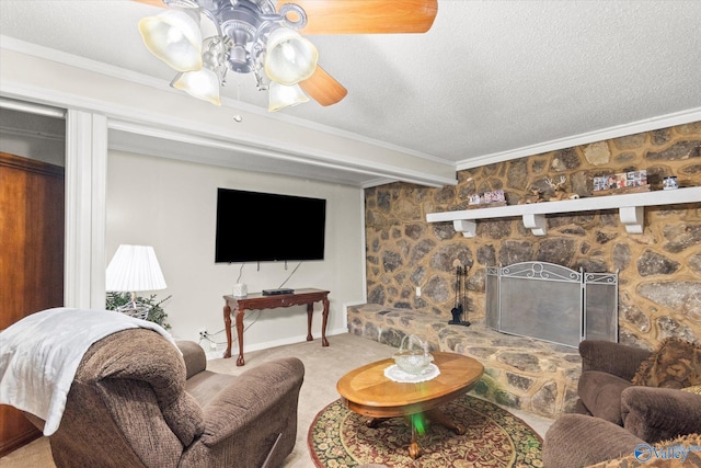 carpeted living area featuring a fireplace, ornamental molding, a ceiling fan, a textured ceiling, and baseboards