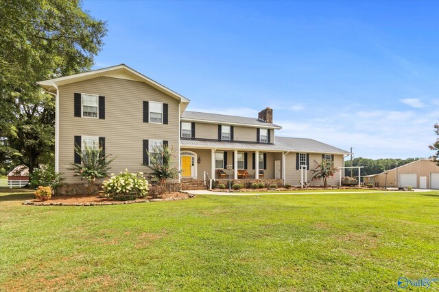 view of front of home featuring covered porch and a front lawn