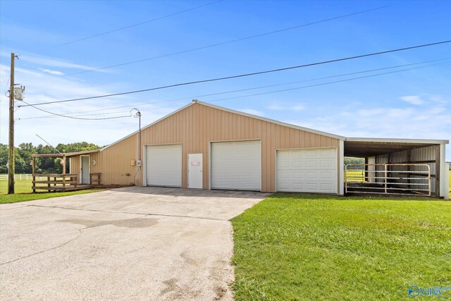 garage featuring a lawn and a carport