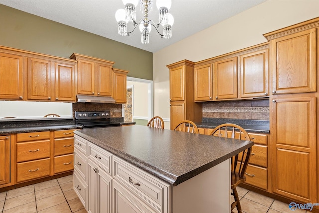 kitchen with tasteful backsplash, an inviting chandelier, a center island, electric range oven, and light tile patterned floors