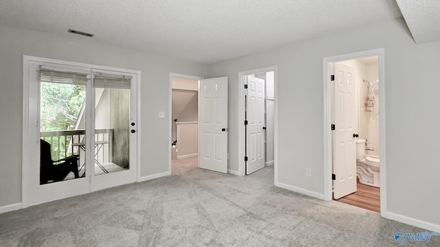 306 Autumn Ln, Madison, AL 35758 - unfurnished bedroom with carpet floors, access to exterior, a textured ceiling, and connected bathroom
