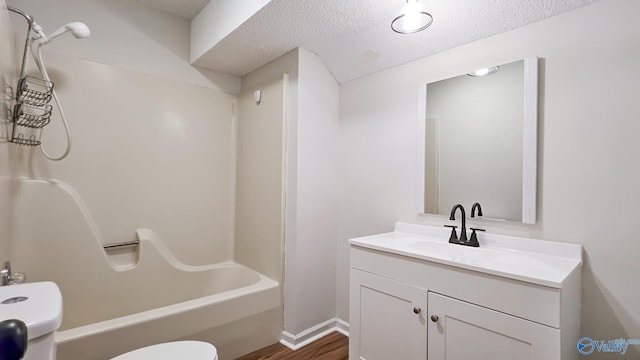 306 Autumn Ln, Madison, AL 35758 - full bathroom featuring vanity, washtub / shower combination, wood finished floors, and a textured ceiling