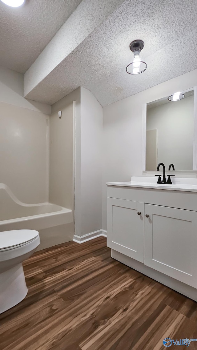 306 Autumn Ln, Madison, AL 35758 - bathroom featuring vanity, wood finished floors, a textured ceiling, and shower / bath combination