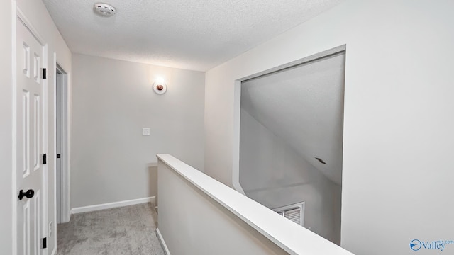 306 Autumn Ln, Madison, AL 35758 - corridor with an upstairs landing, a textured ceiling, and light carpet