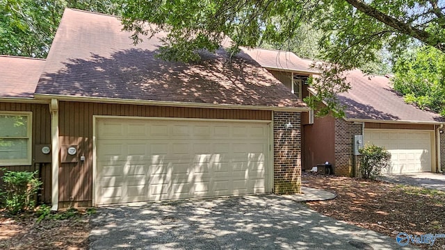 306 Autumn Ln, Madison, AL 35758 - view of front of home featuring asphalt driveway, brick siding, roof with shingles, and a garage