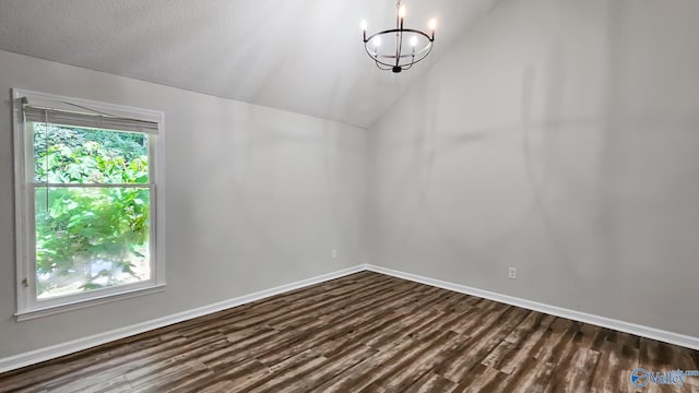306 Autumn Ln, Madison, AL 35758 - empty room featuring dark wood-type flooring, plenty of natural light, a chandelier, and lofted ceiling