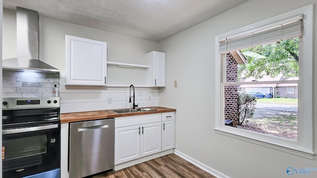 306 Autumn Ln, Madison, AL 35758 - kitchen featuring stainless steel appliances, wood counters, wall chimney exhaust hood, dark wood-style floors, and backsplash