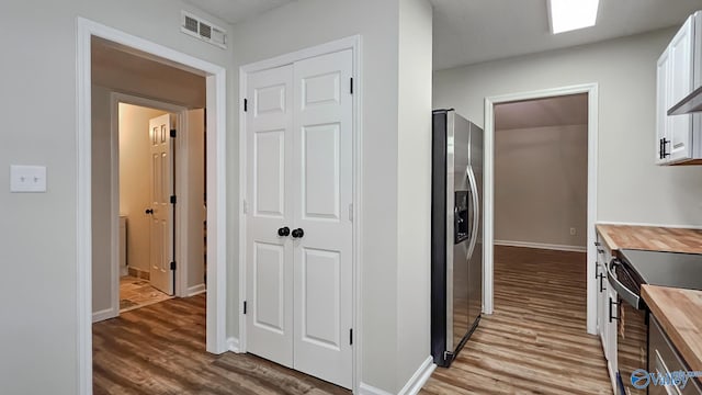 306 Autumn Ln, Madison, AL 35758 - kitchen featuring wooden counters, stainless steel appliances, wood finished floors, and white cabinetry